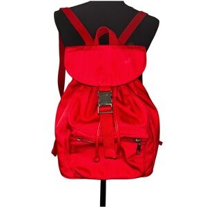Red nylon little travel backpack with drawstring and snap closure